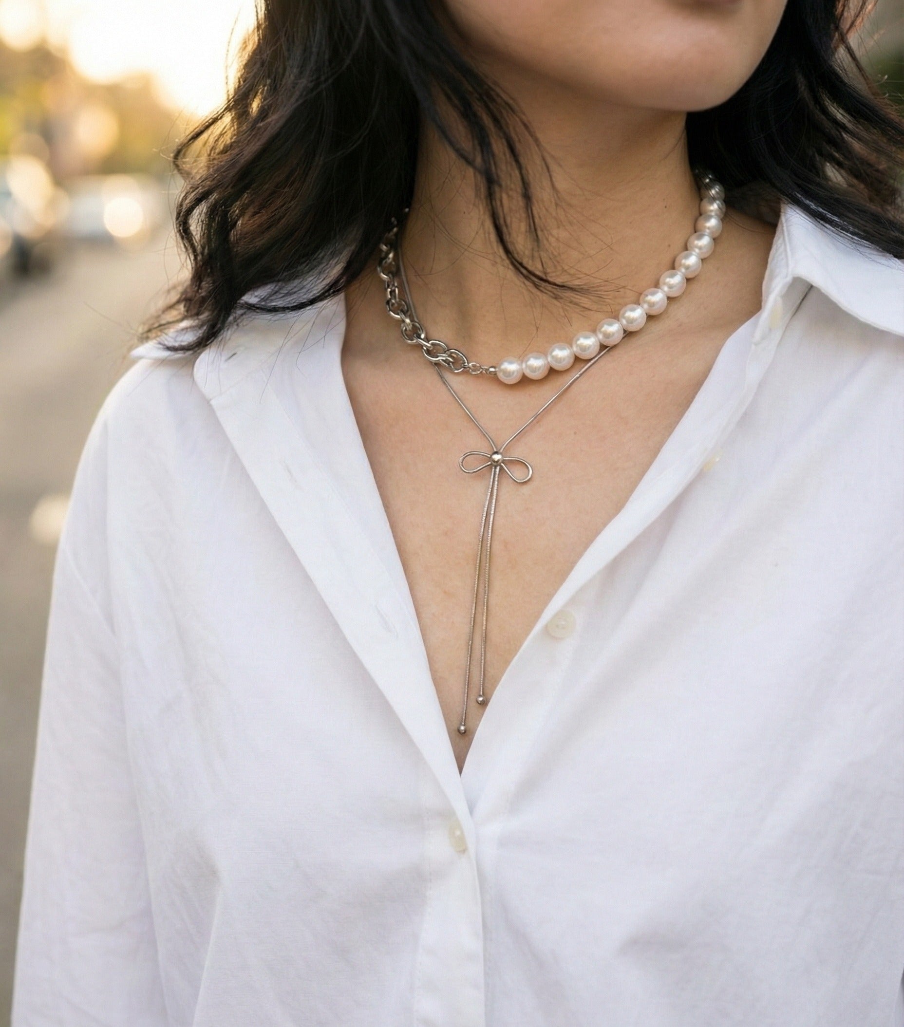 Layered necklace look with silver bow lariat and pearl necklace - Balletcore aesthetic jewelry