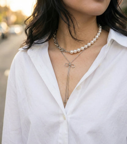 Layered necklace look with silver bow lariat and pearl necklace - Balletcore aesthetic jewelry
