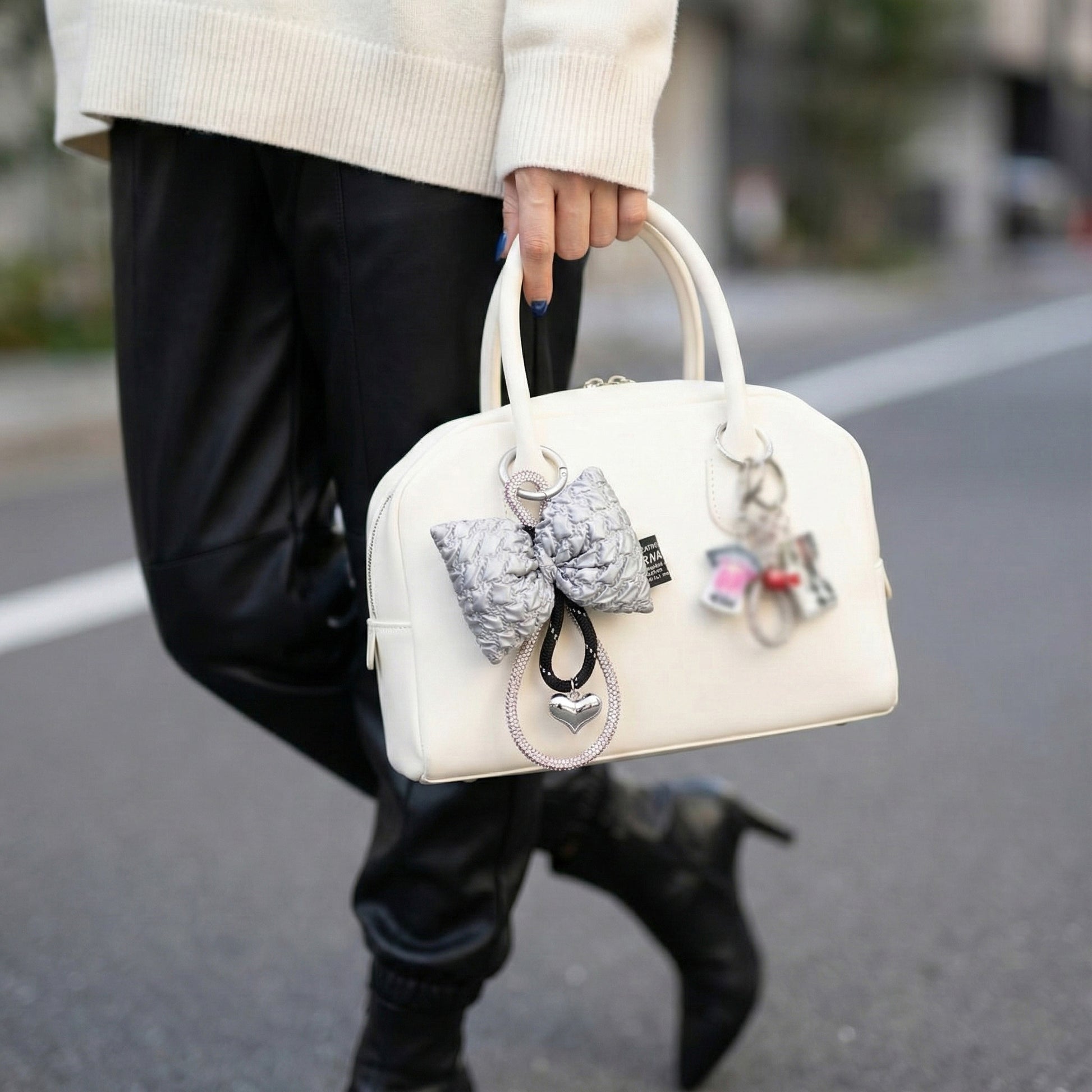 Metallic silver padded bow keychain on white bowling bag balletcore aesthetic