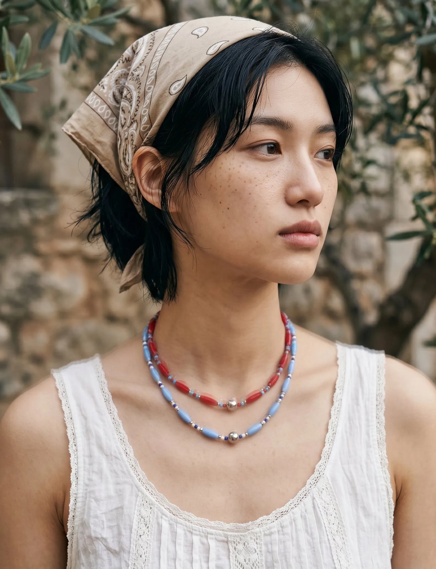 Boho bandana look beaded necklace stack, red and blue, vacation bandana outfit styling.