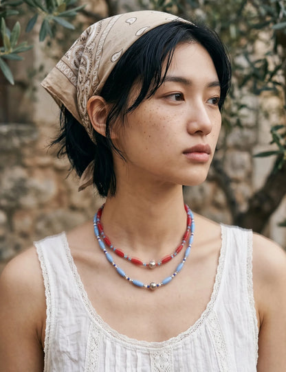Boho bandana look beaded necklace stack, red and blue, vacation bandana outfit styling.