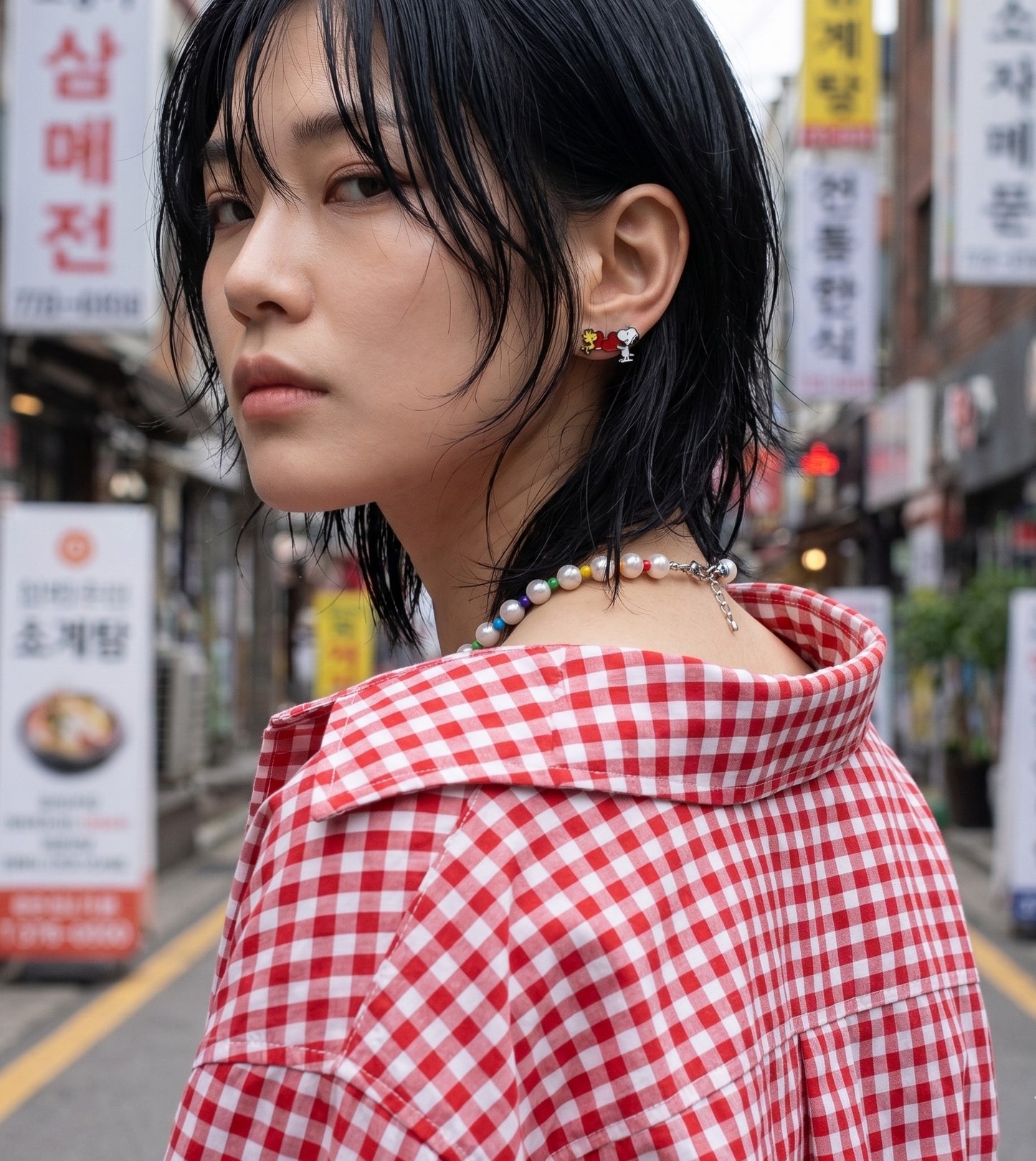 K-fashion downtown girl vibe, rainbow bead pearl necklace worn with Snoopy enamel stud earrings.