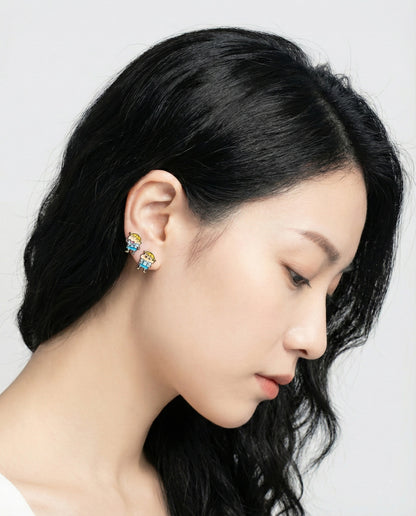 Side view of model wearing both Shin-chan and Max kawaii anime earrings