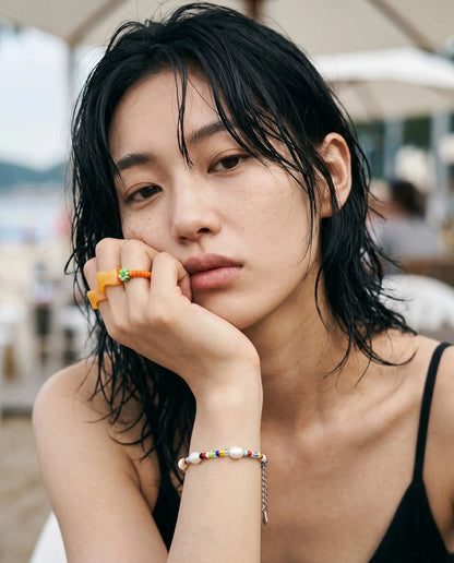 
K-summer stack inspo — orange chunky wave ring and beaded flower ring paired with freshwater pearl color bead bracelet by 8ttitto8.