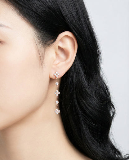 Crystal clear clover drop earrings with rose gold plating on model