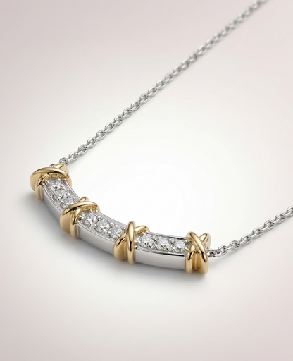 Two-tone 925 sterling silver curved bar necklace with cubic zirconia and gold X-cross accents on neutral background