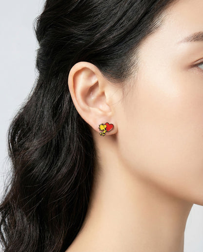 Close-up view of Woodstock heart earring on ear
