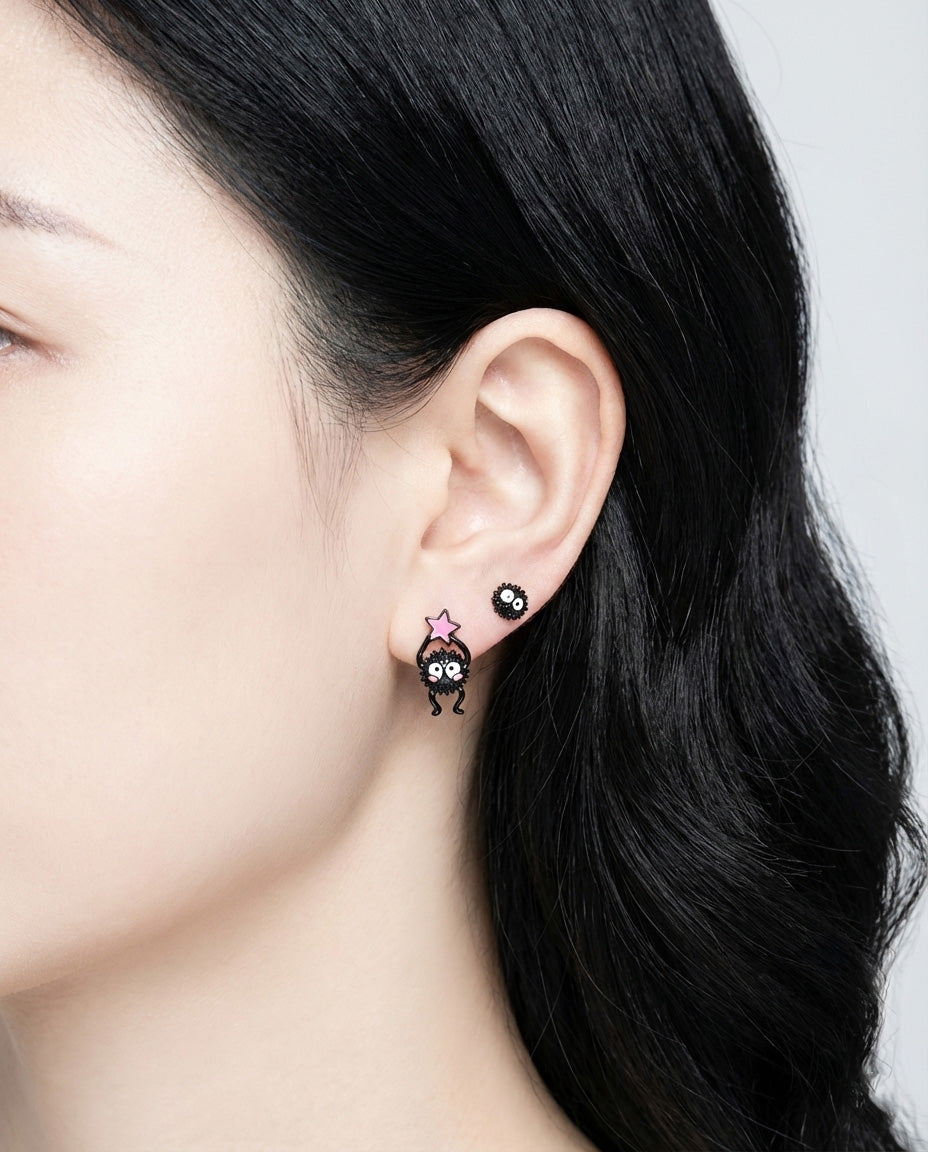 Model wearing asymmetric pink star candy Soot Sprite earring with classic sprite stud