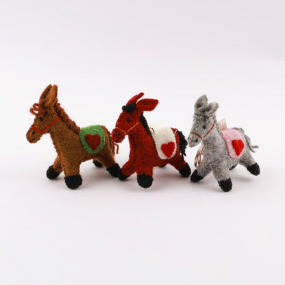 Three needle felted horse keychains lined up - brown, red, and grey - showing heart detail