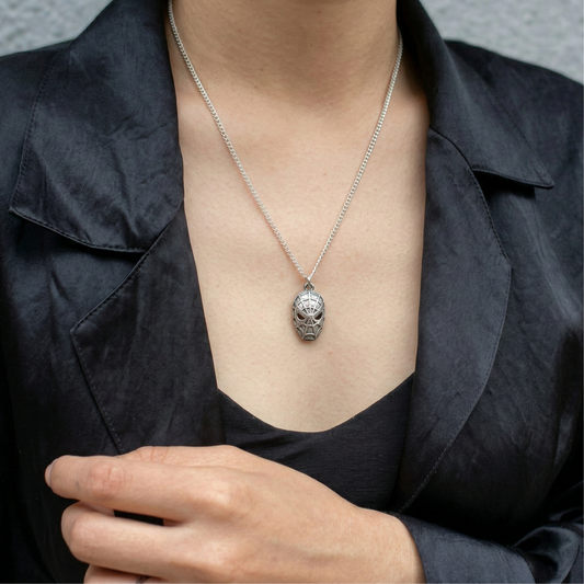 Woman wearing a unique silver spider pendant necklace with a black blazer