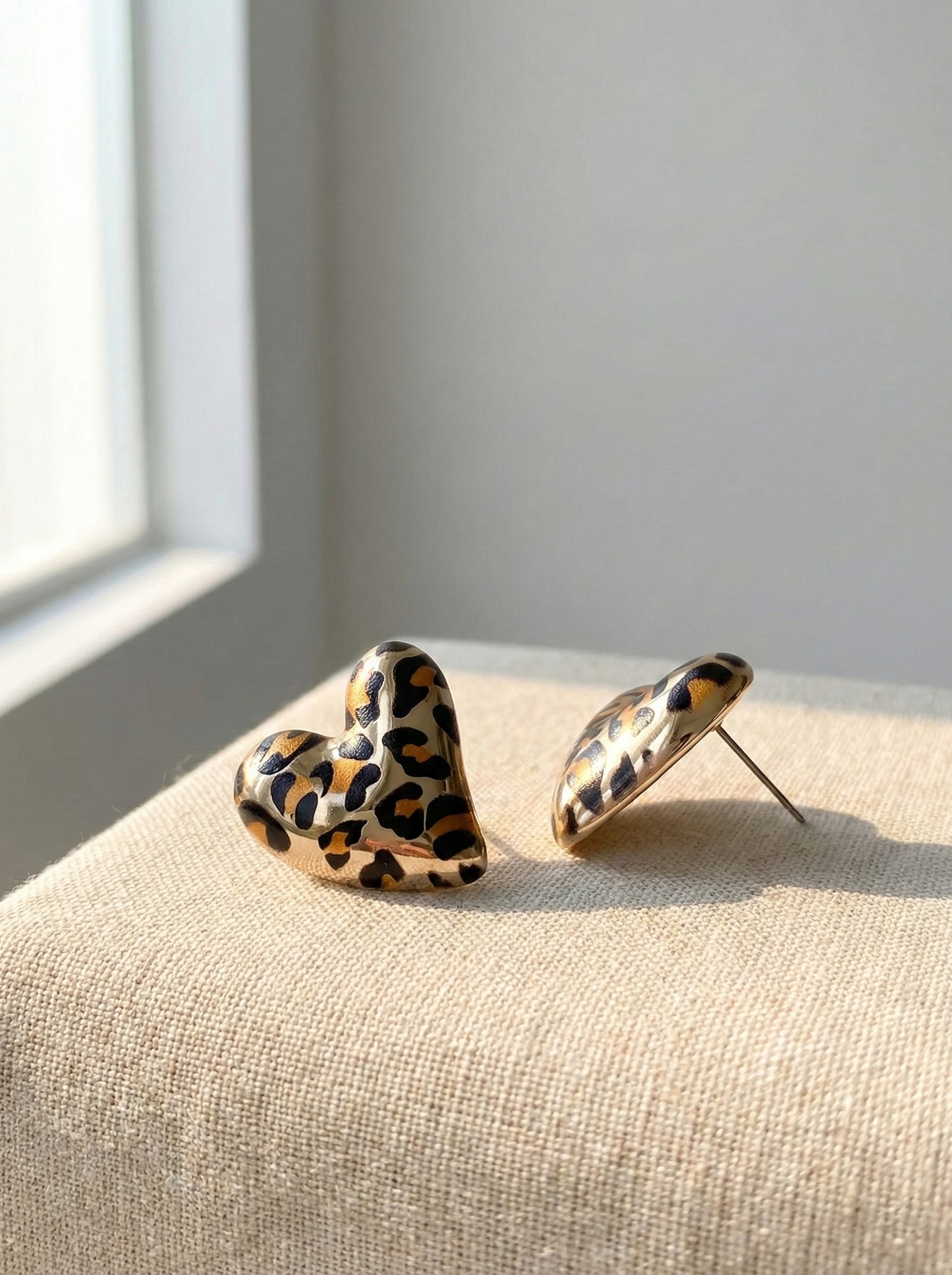Leopard heart earrings close-up showing gold plating and animal print detail