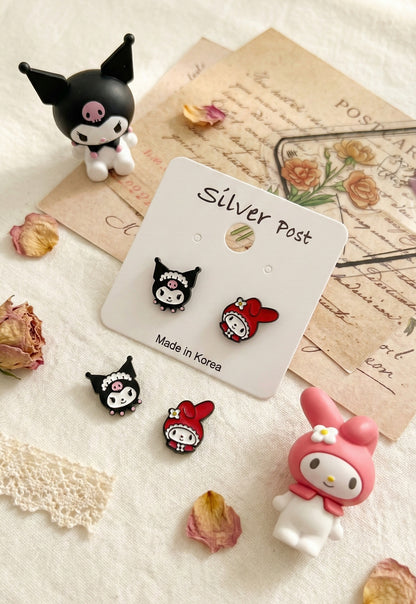 Detailed product shot of Kuromi and My Melody asymmetrical earring set on vintage letters