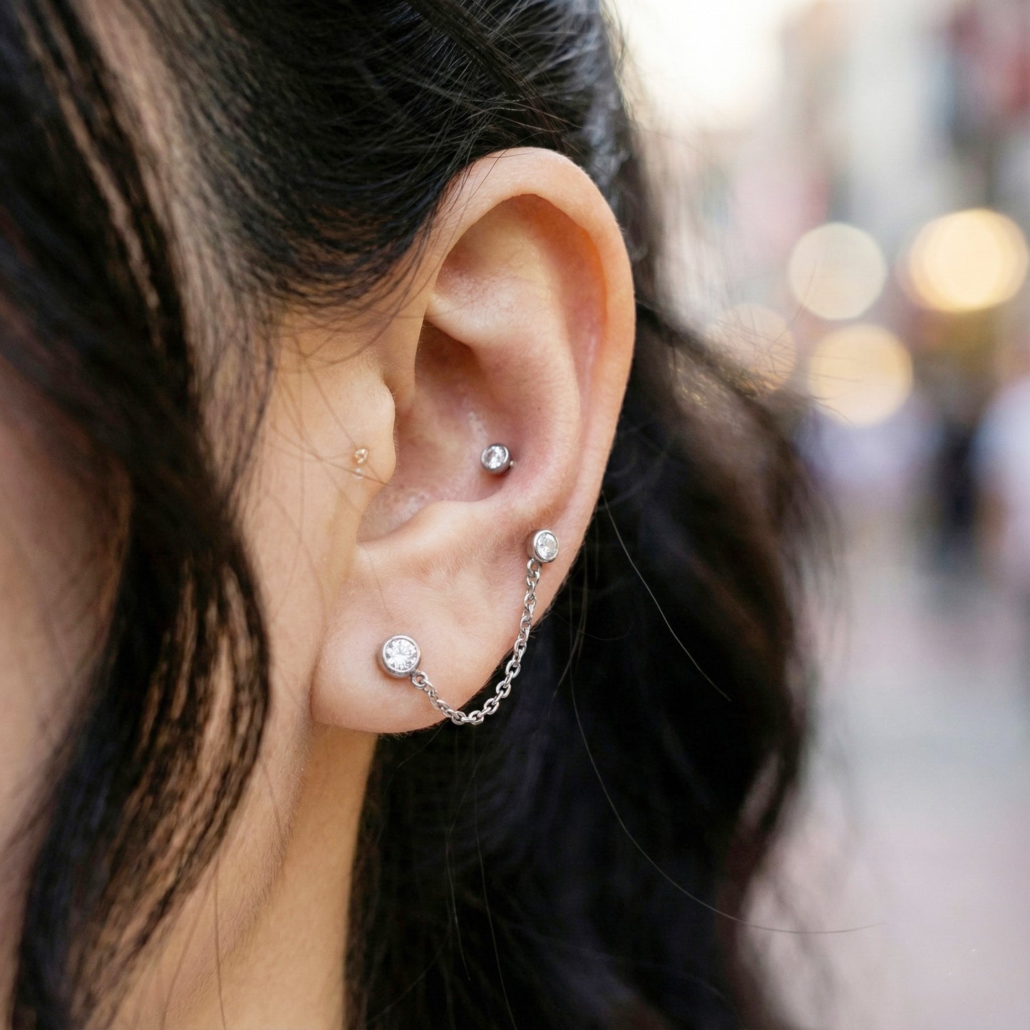 Silver surgical steel chain piercing earring on model