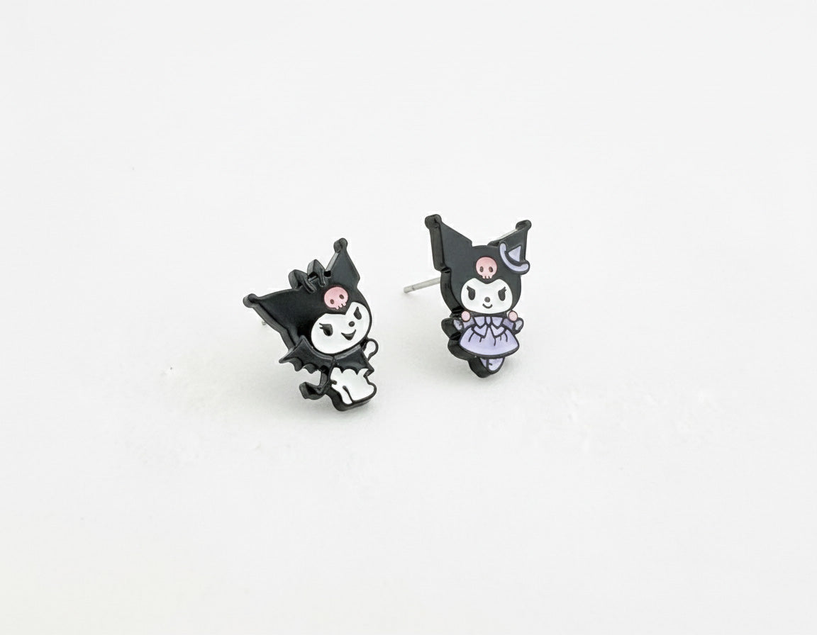 Two Kuromi-themed enamel stud earrings on a white background—one in a classic outfit, the other in a lavender dress.