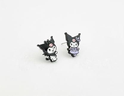 Two Kuromi-themed enamel stud earrings on a white background—one in a classic outfit, the other in a lavender dress.
