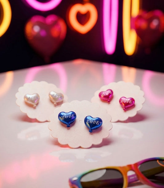 Three pairs of heart balloon earrings in pink blue and champagne with neon lights