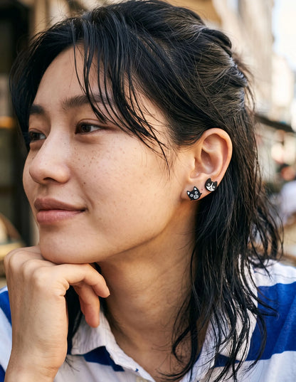 Black cat and white cat enamel stud earrings layered on one ear — cat mom jewelry, K-style curated ear, mismatch studs handmade in Korea