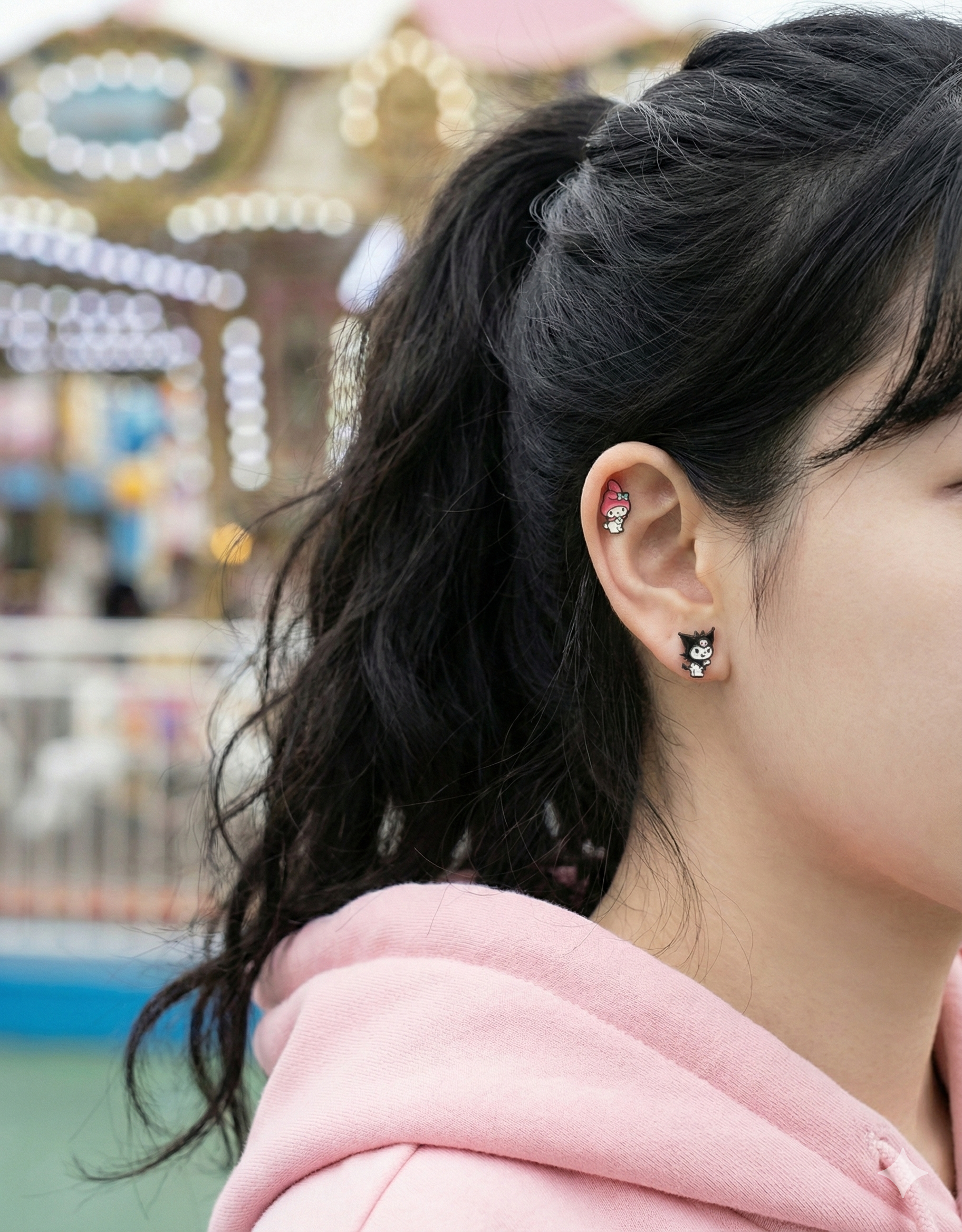 Ear styling with My Melody on helix and Kuromi on lobe for kawaii layered piercing look