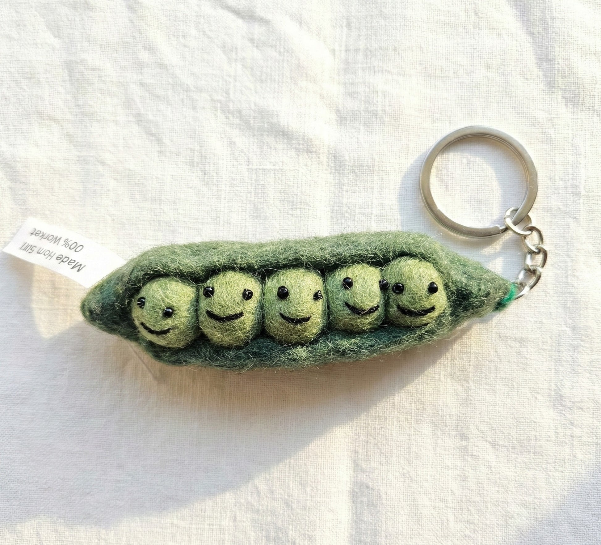 Five peas in a pod needle felt keychain with smiling faces