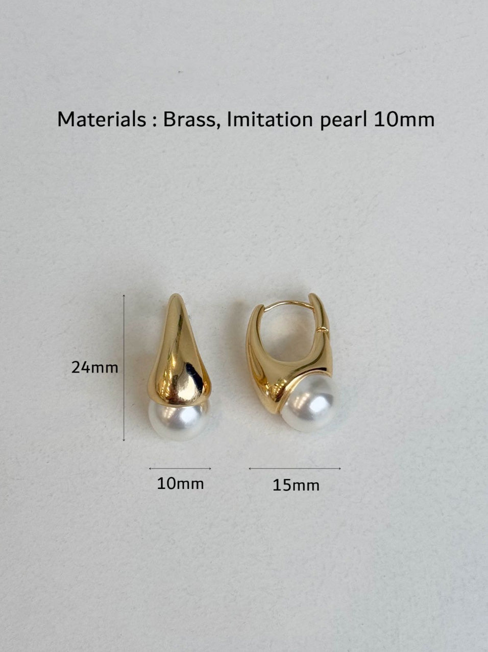 Flat lay of gold teardrop pearl earrings with size measurements showing 24mm length and 10mm pearl