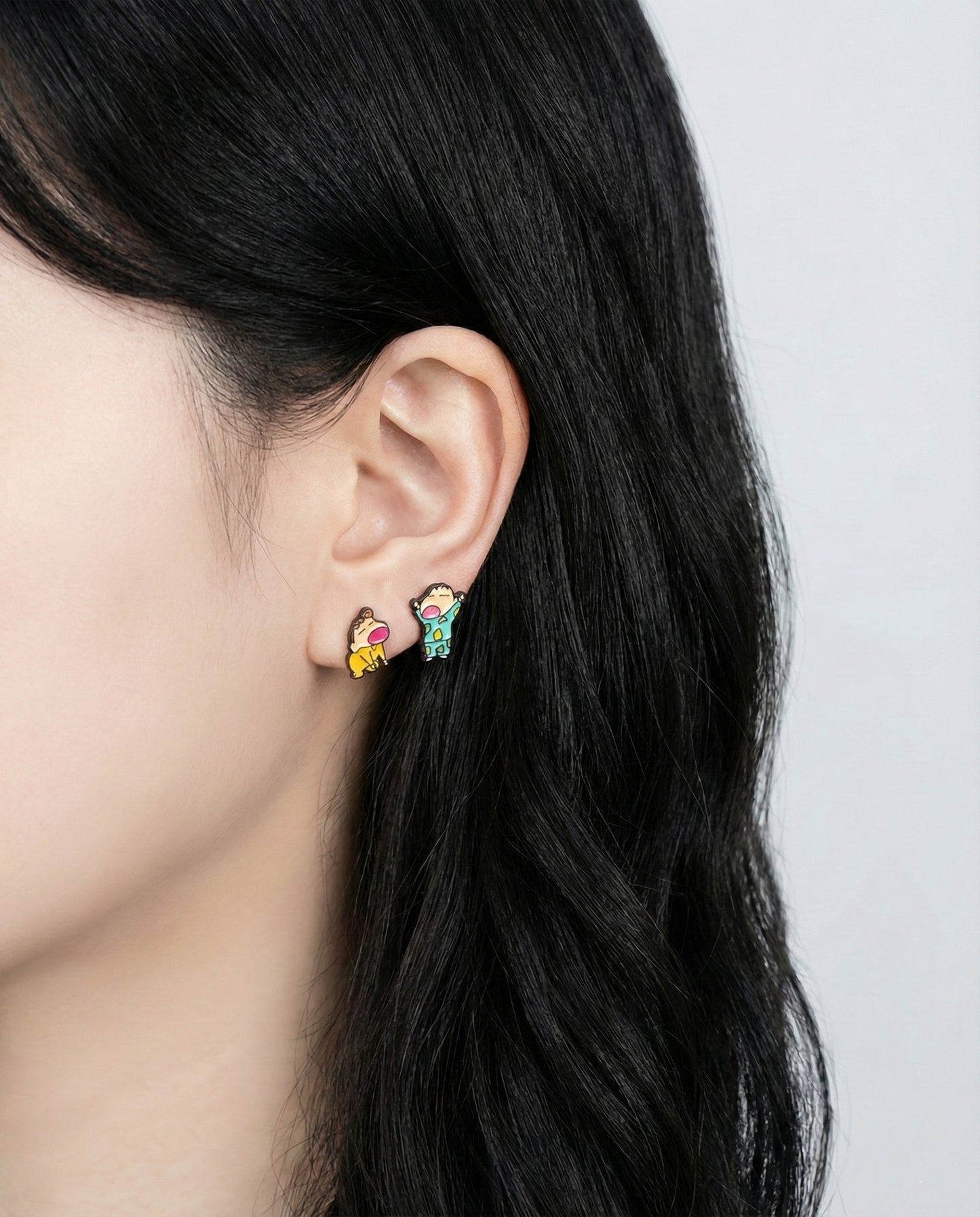 Model showcasing Crayon Shin-chan siblings earrings from rear angle with hair down