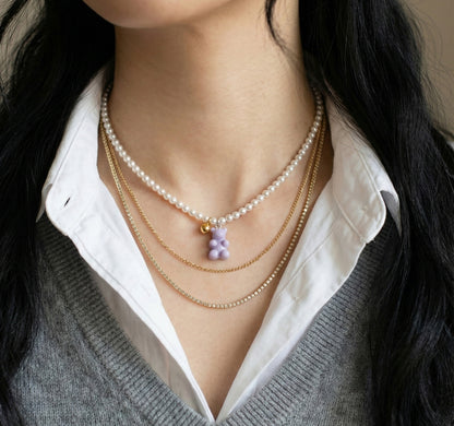 Swarovski pearl necklace layered with gold chain necklaces - minimalist jewelry styling