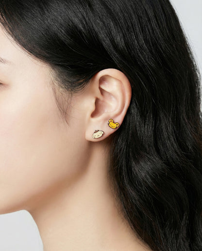 Pompompurin yellow character earrings with banana and flower enamel studs on ear