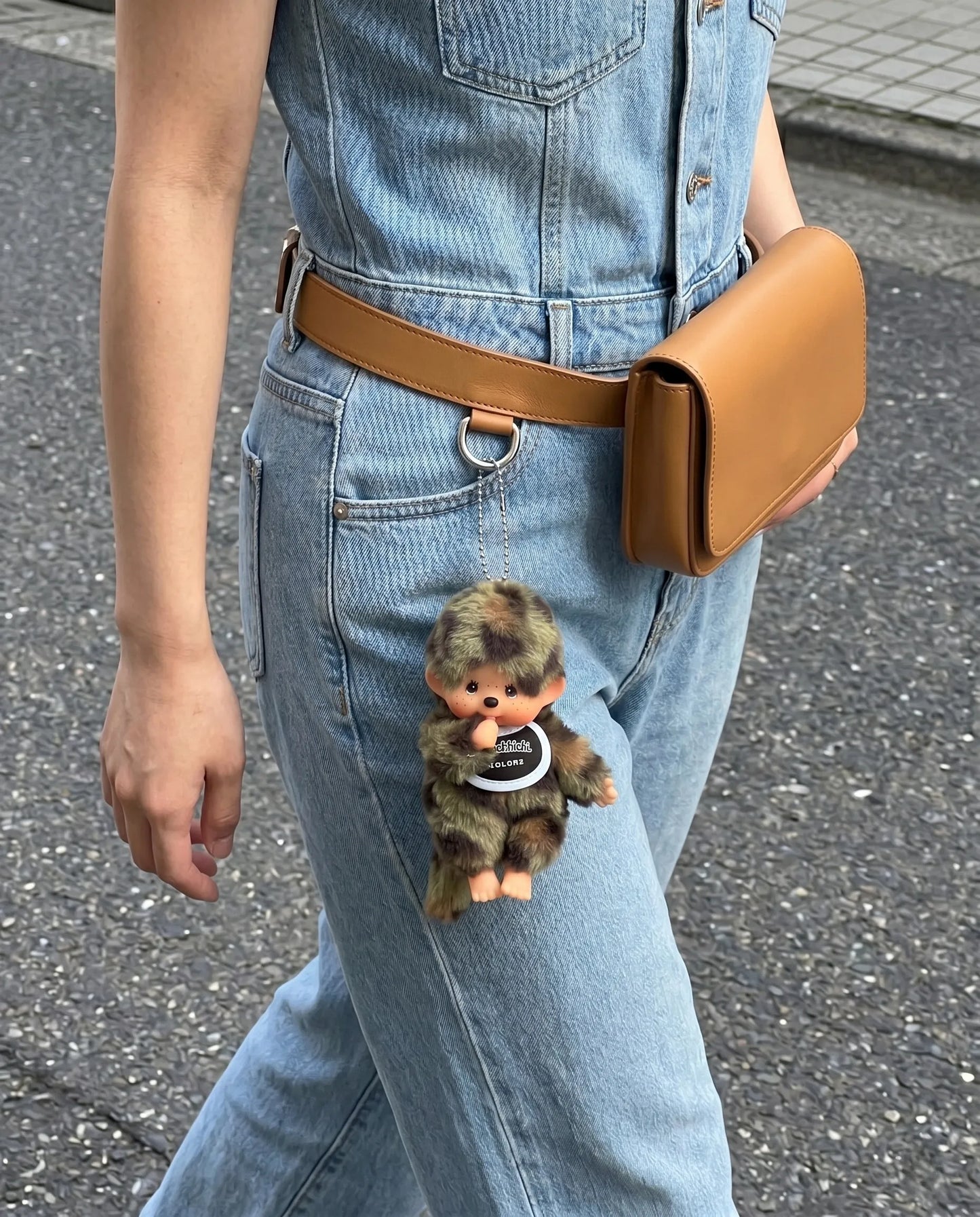 Street style belt bag look with camo plush doll keychain 8ttitto8 dangling from denim jumpsuit waist bag, soft grunge everyday carry.