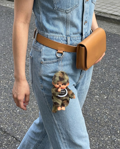 Street style belt bag look with camo plush doll keychain 8ttitto8 dangling from denim jumpsuit waist bag, soft grunge everyday carry.