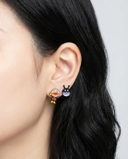 Close-up of Anpanman and Baikinman earrings worn on ear
