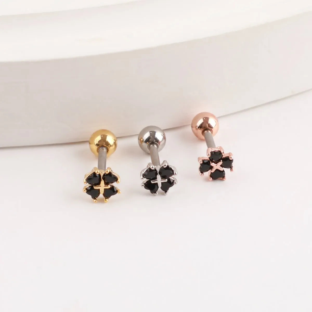 K-style cubic clover piercing trio, gold silver rose gold cartilage stud inspo.