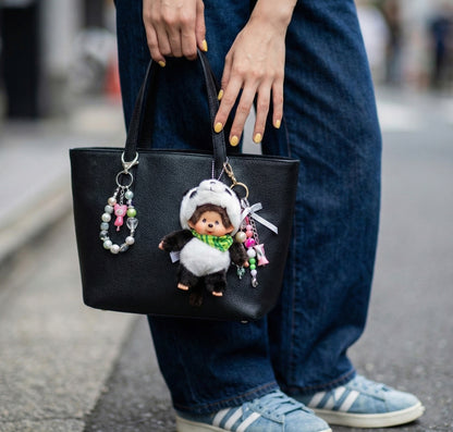 Street style photo black leather tote bag with panda Monchhichi charm