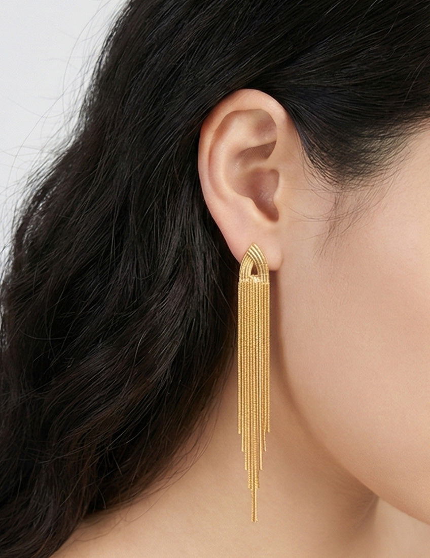 Angled shot of gold shoulder duster earrings showing cascading chain movement, party jewelry