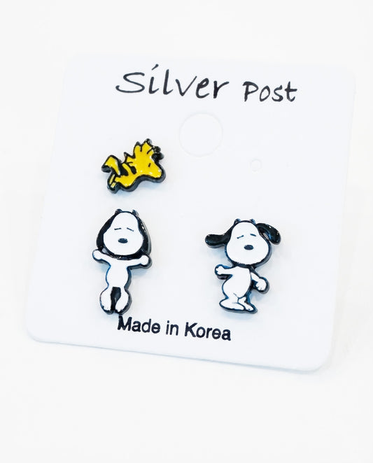 Flat lay of 3-piece earring set showing two Snoopy poses and one Woodstock on white card