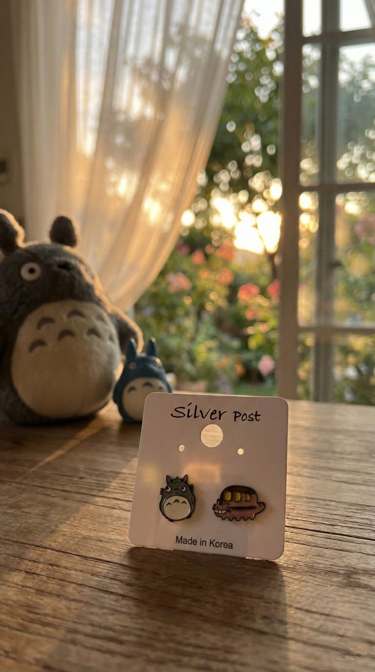 Totoro Catbus asymmetrical earrings on white card packaging with Silver Post label
