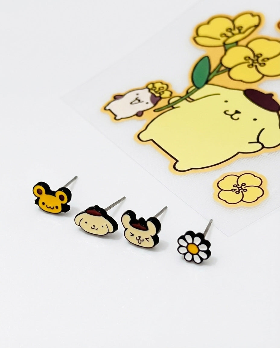 Four piece Pompompurin earring set displayed with character faces flower bee and banana motifs