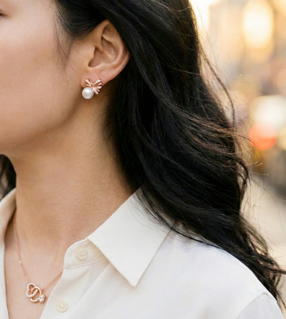 
Rose gold ribbon bow pearl earrings outdoor shot, wedding guest jewelry