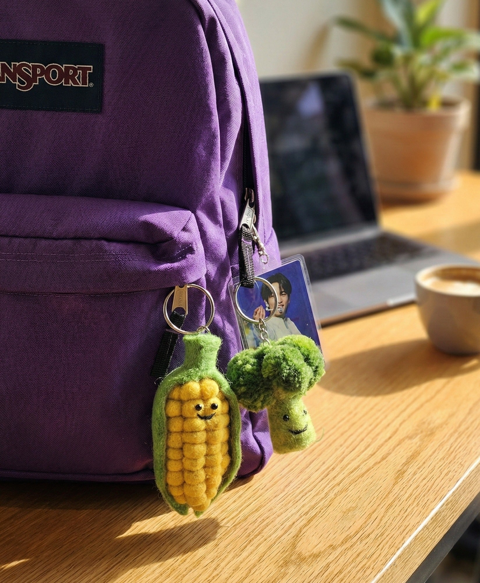 Purple backpack decorated with corn and broccoli veggie keychains