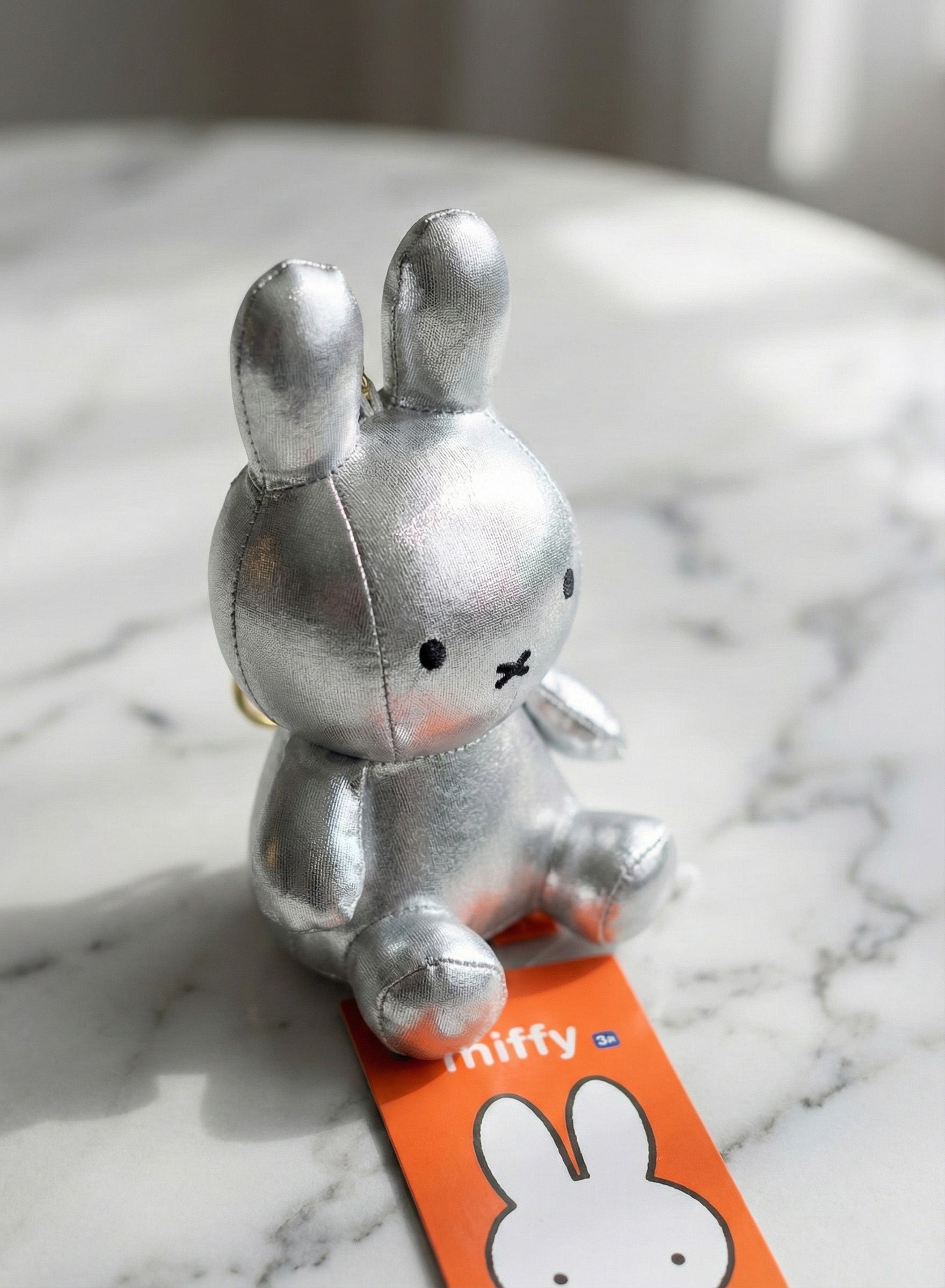 Silver chrome Miffy keychain with futuristic metallic finish - trending accessory