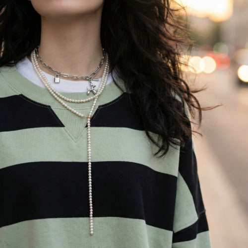  Multi-layered necklace styling with pearl, beaded flower, and balloon dog necklaces