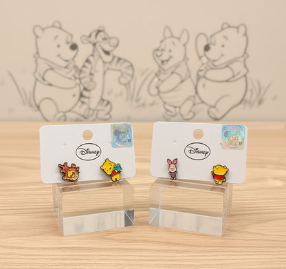 Disney licensed Winnie the Pooh character earrings displayed with sketch background, authentic merchandise