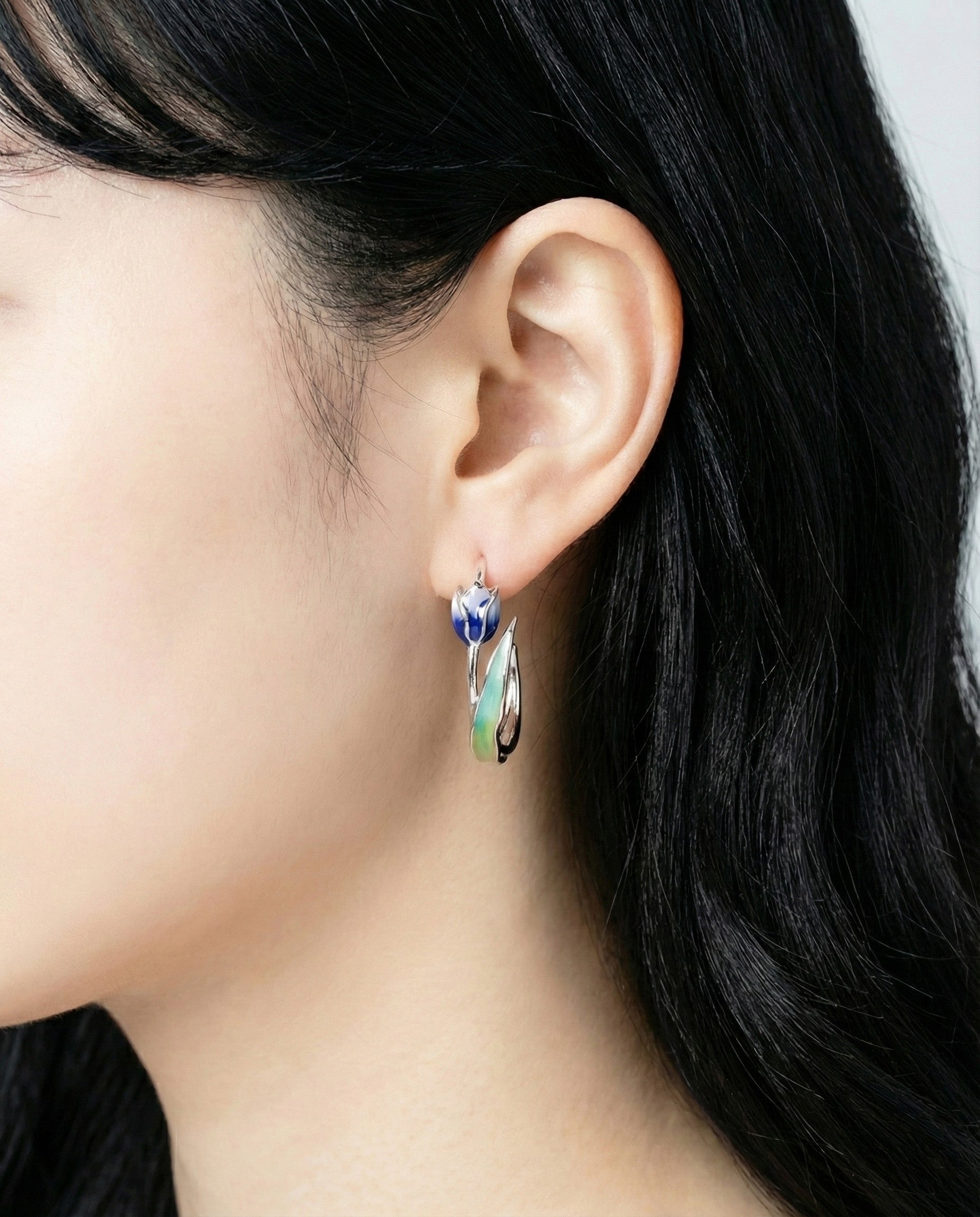 Side angle of blue tulip flower hoop earring showing 3D craftsmanship