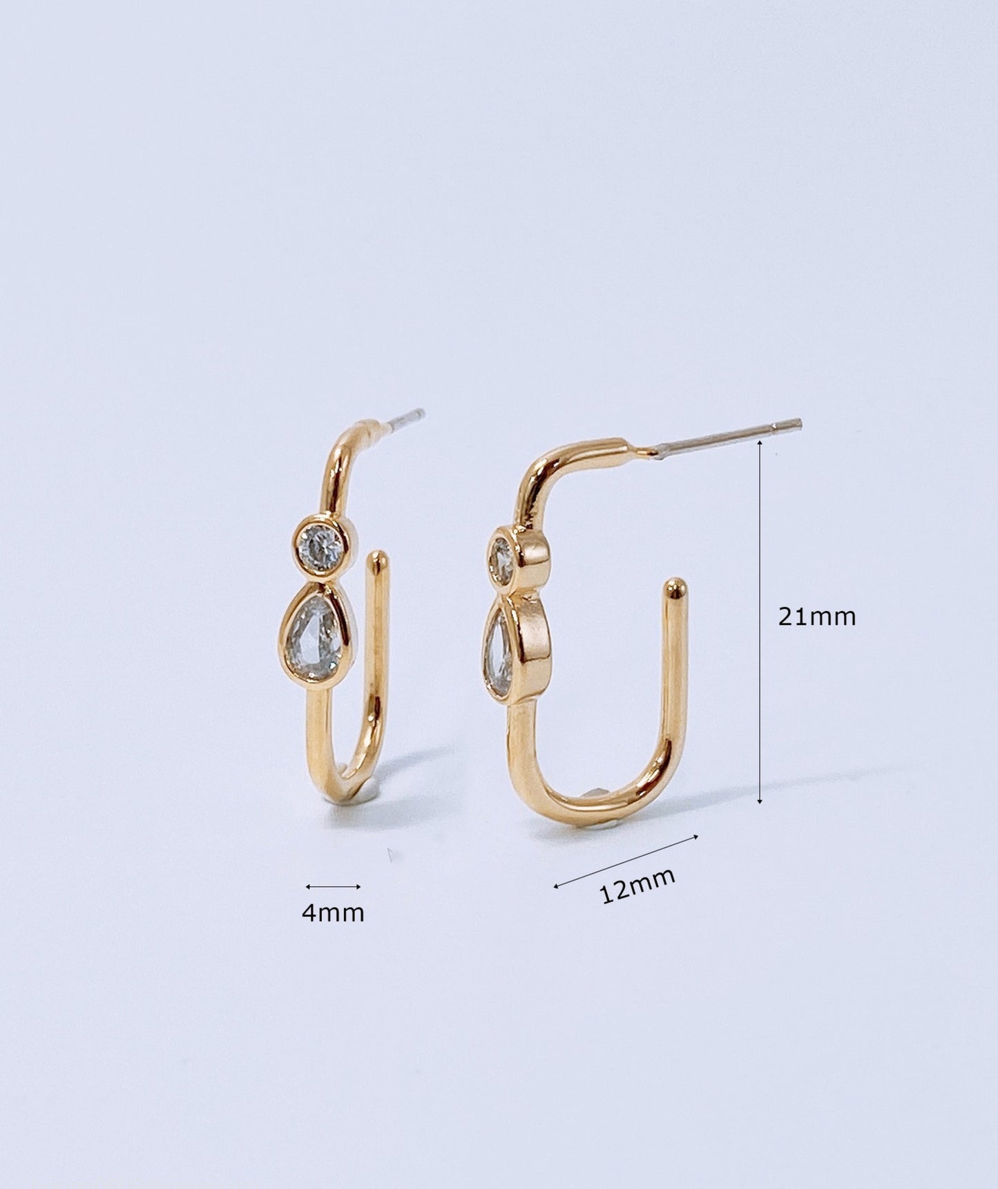 Product dimension measurement of gold bezel-set U-hoop earrings showing 21mm height and 12mm width with titanium post