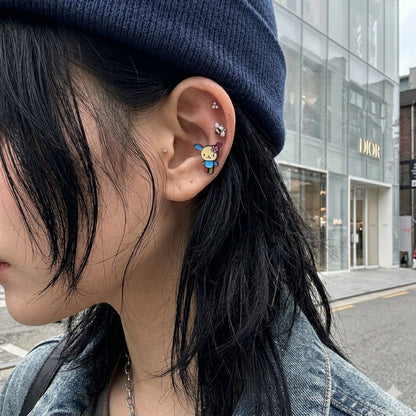 Y2K mismatch ear stack bumblebee CZ piercing with kawaii character stud, Stussy beanie Seoul street style earscape.