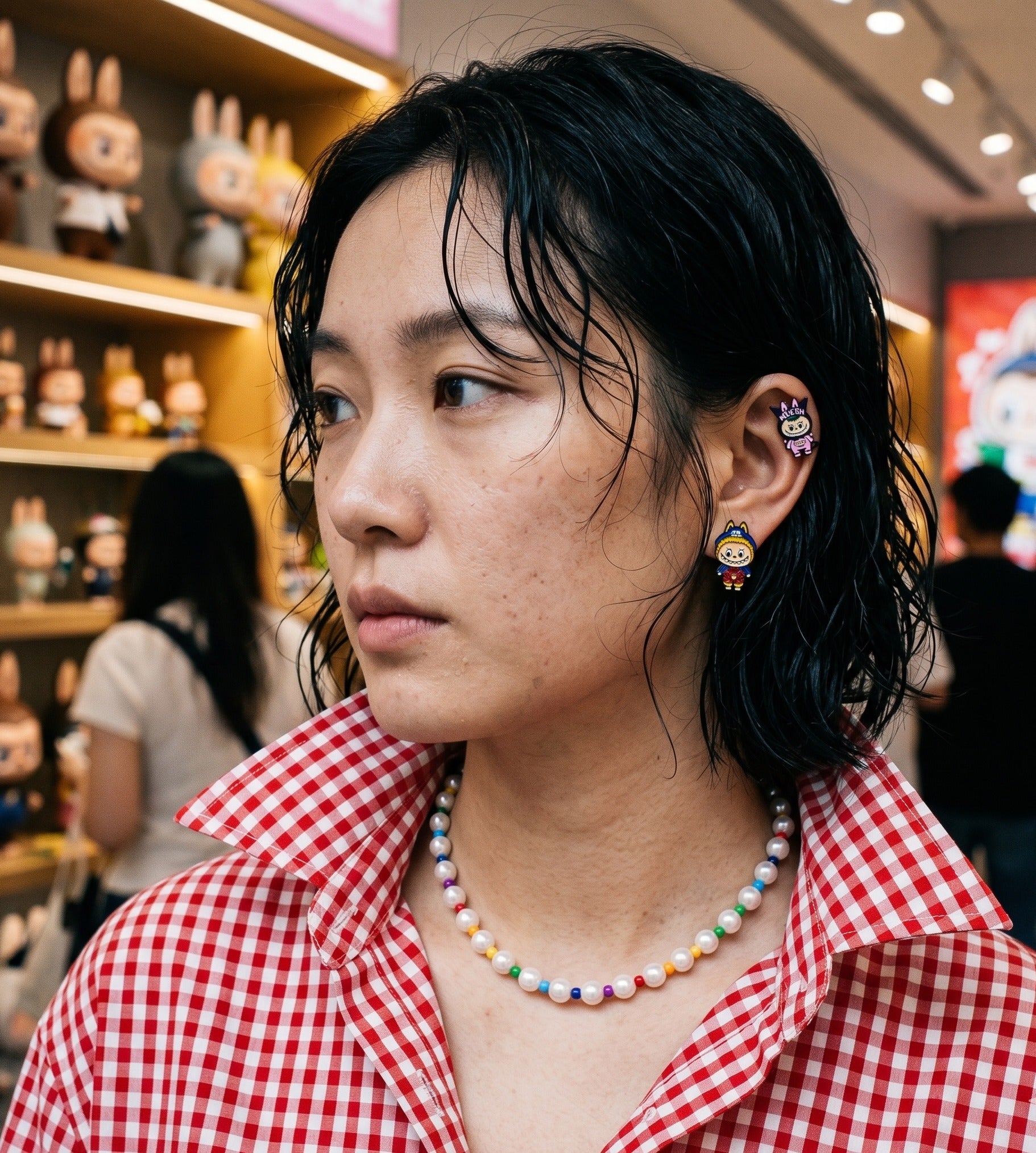 Art toy pop-up aesthetic, Labubu character ear cuff paired with kidcore rainbow bead pearl necklace.