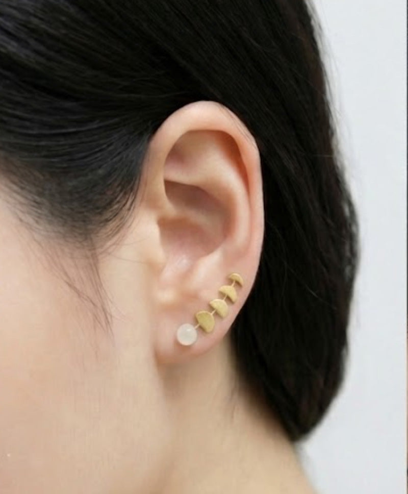 Gold moon phase ear climbers with faux moonstone worn on ear
