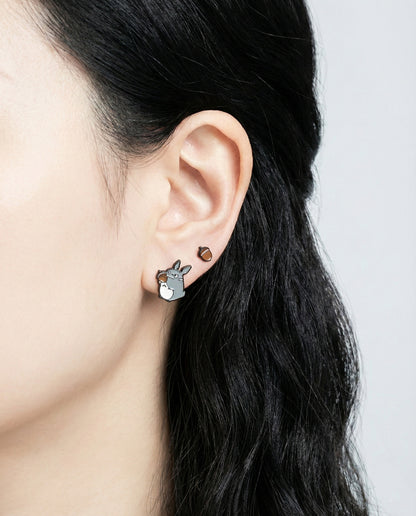 Catbus character stud earring worn on ear with brass and enamel detailing`
