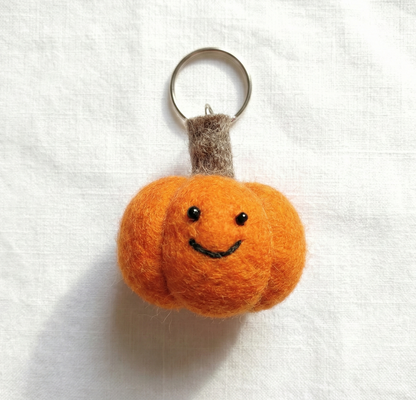 Orange pumpkin felt keychain with brown stem detail