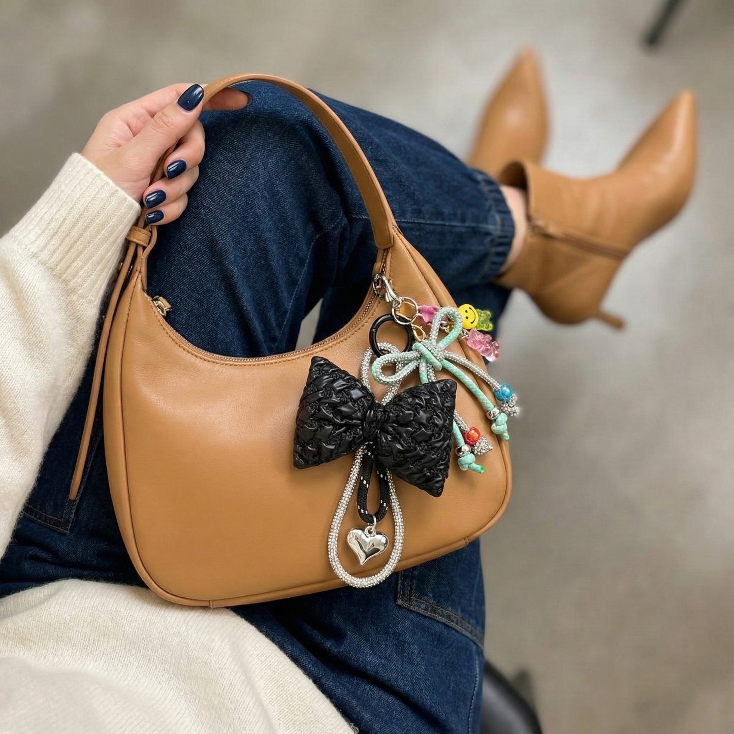 Camel leather hobo bag with mint rope bow charm and black bow pendant layered styling