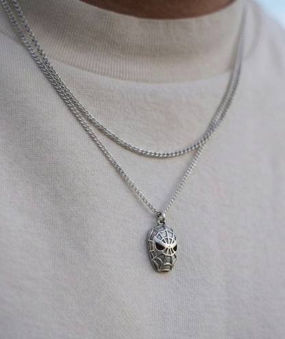 Close up of a man wearing a unisex vintage silver character pendant on a long chain